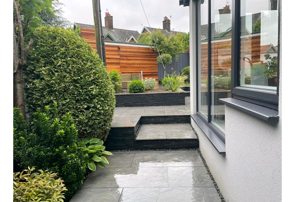 Stepped Rear Garden, Bungay - Stepped Rear Garden Design - The porcelain patio wraps around the house