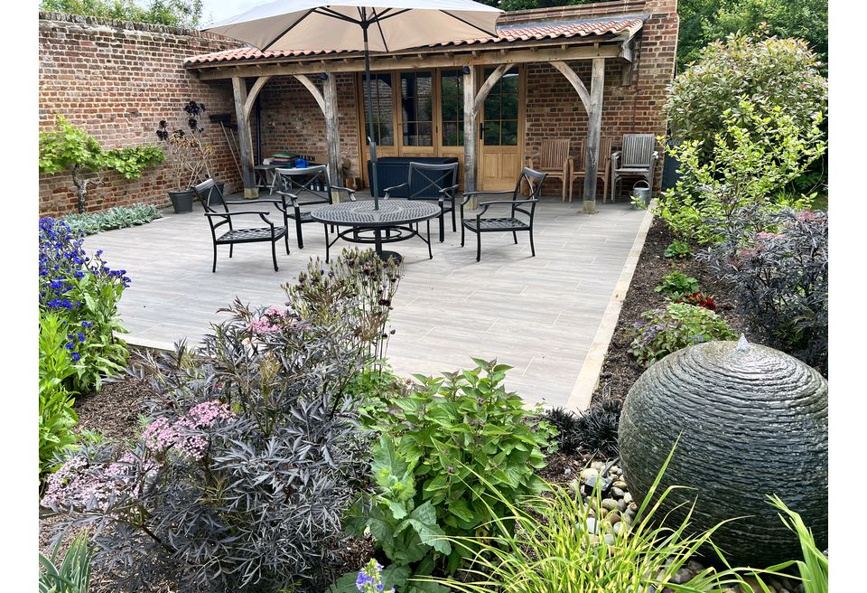 Cottage Garden Gin Terrace - Wymondham  - Slate Ball Water Feature nestled into the new low maintenance Planting Scheme